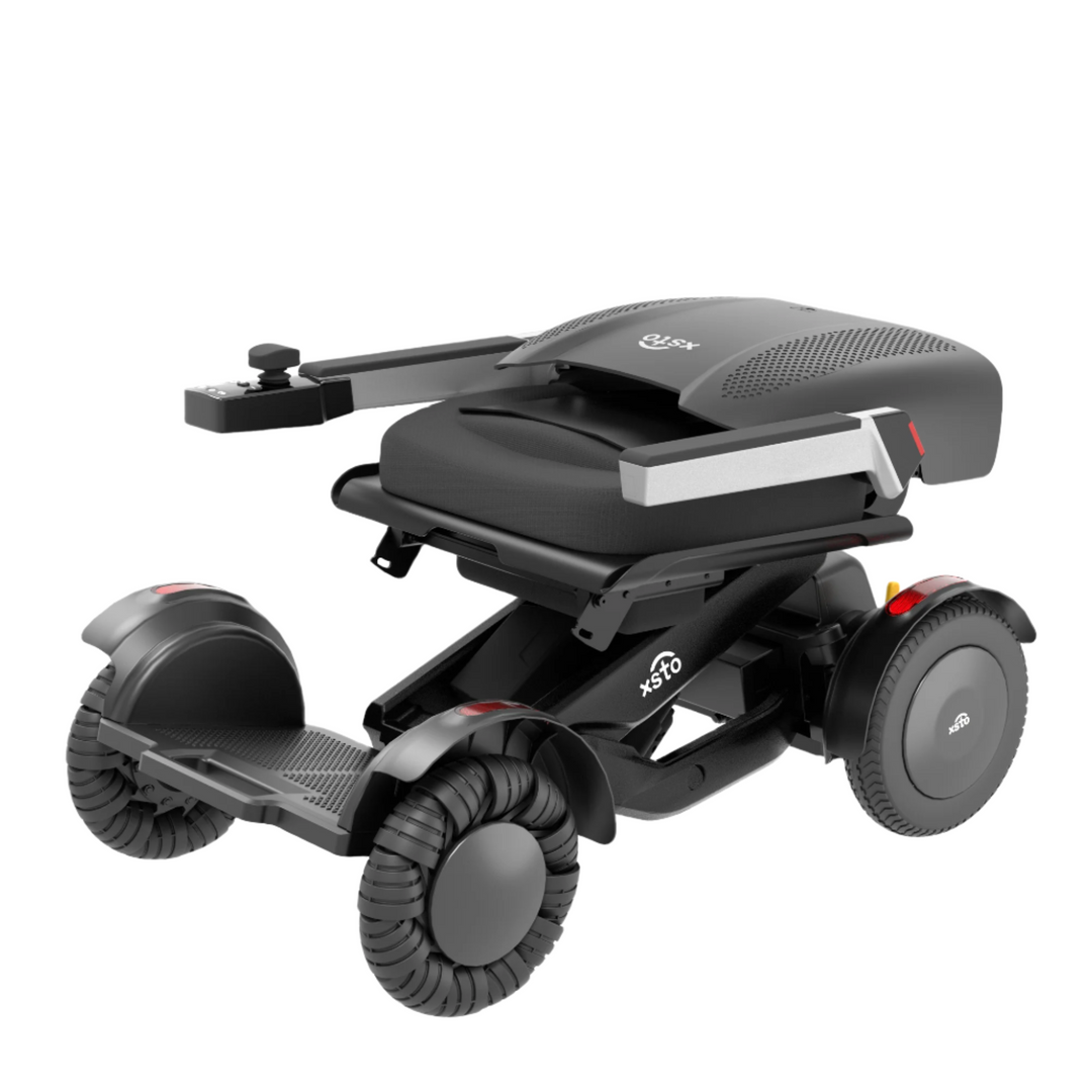 M4 Electric Wheelchair - by XSTO side angle view, folded down showing wheels frame arm rest down