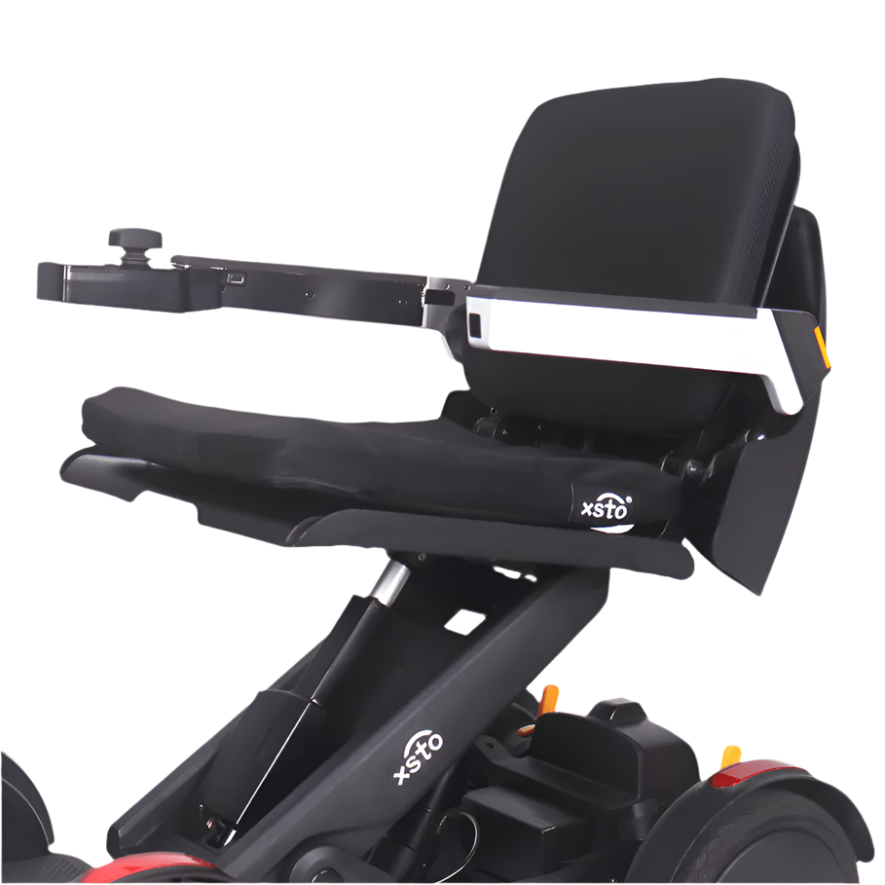 electric wheelchair, black cusion with the words xsto m4 on side and on frame of wheel chair