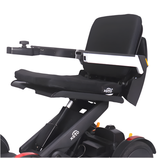 electric wheelchair, black cusion with the words xsto m4 on side and on frame of wheel chair